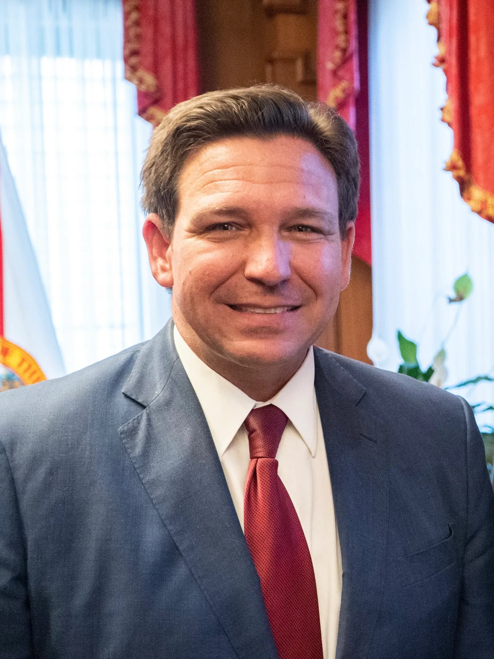 Florida Governor Ron DeSantis in an office group-photo setting.