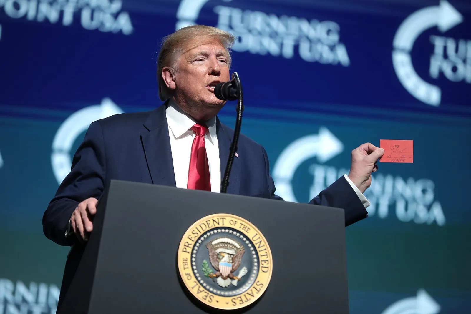 Donald Trump holds a sign reading ‘No’ at the 2019 Student Action Summit.