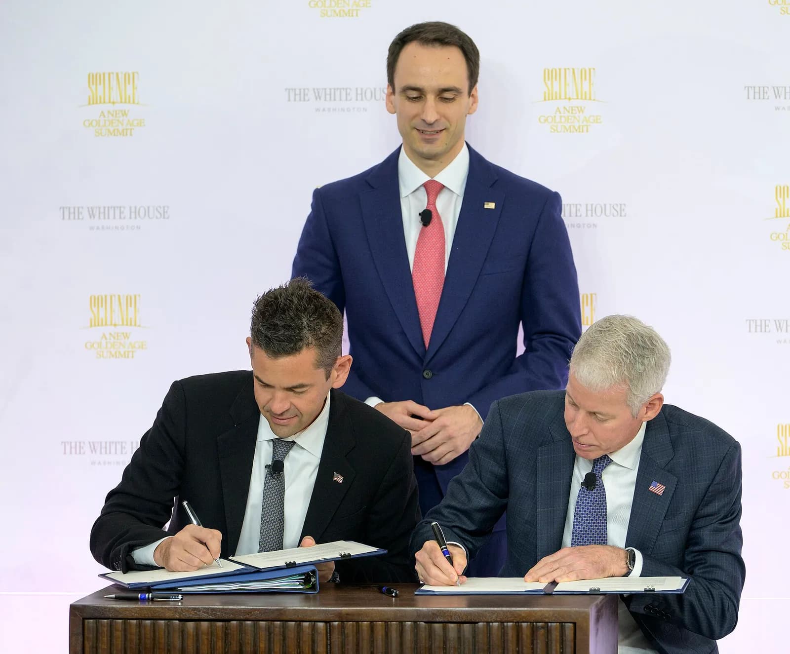 NASA Administrator Jared Isaacman and Energy Secretary Chris Wright sign a space nuclear cooperation memorandum as OSTP Director Michael Kratsios watches.