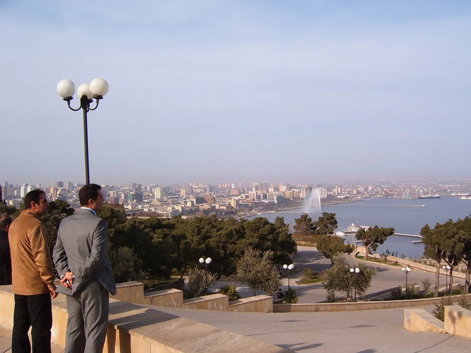 View across Baku’s skyline and waterfront, with two men in the foreground