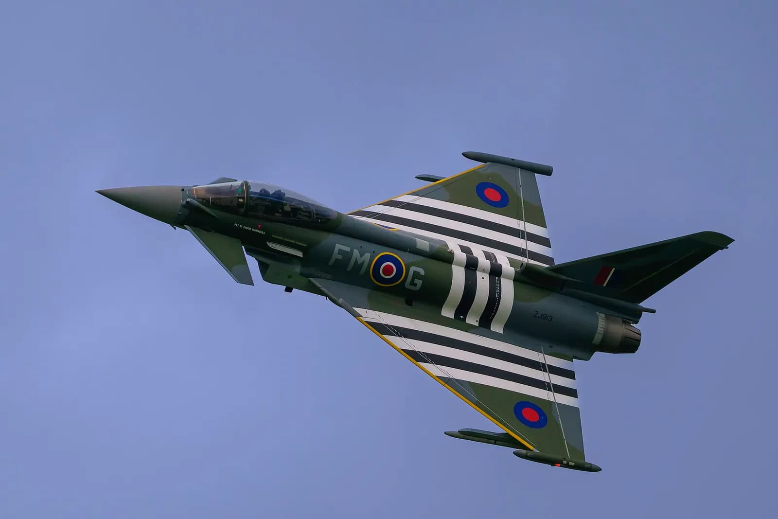 A Royal Air Force Typhoon fighter aircraft performing a display at RAF Cosford airshow.