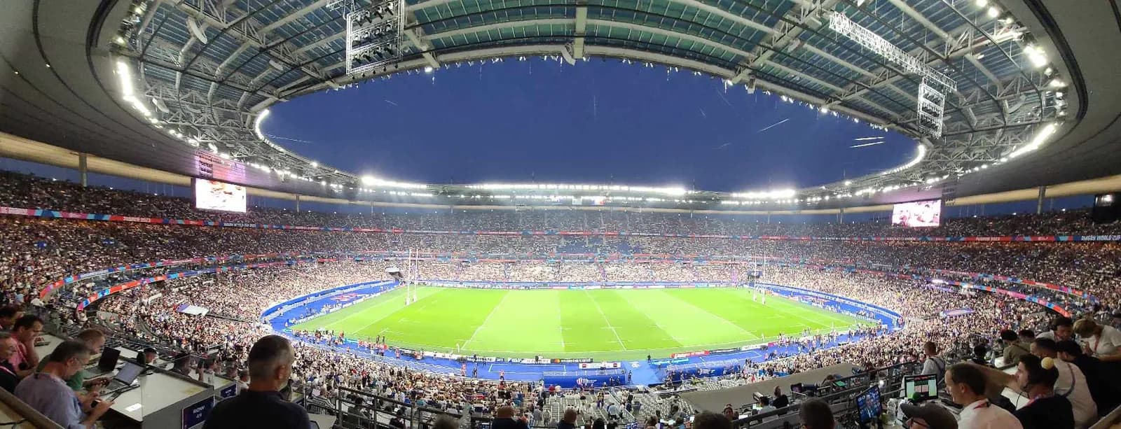 Panoramic view of the Stade de France interior, with the pitch and stands visible.