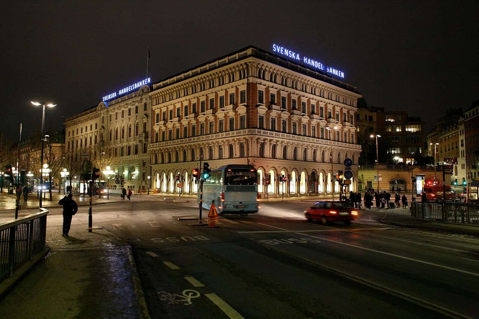 Svenska Handelsbanken’s illuminated headquarters in Stockholm at night.
