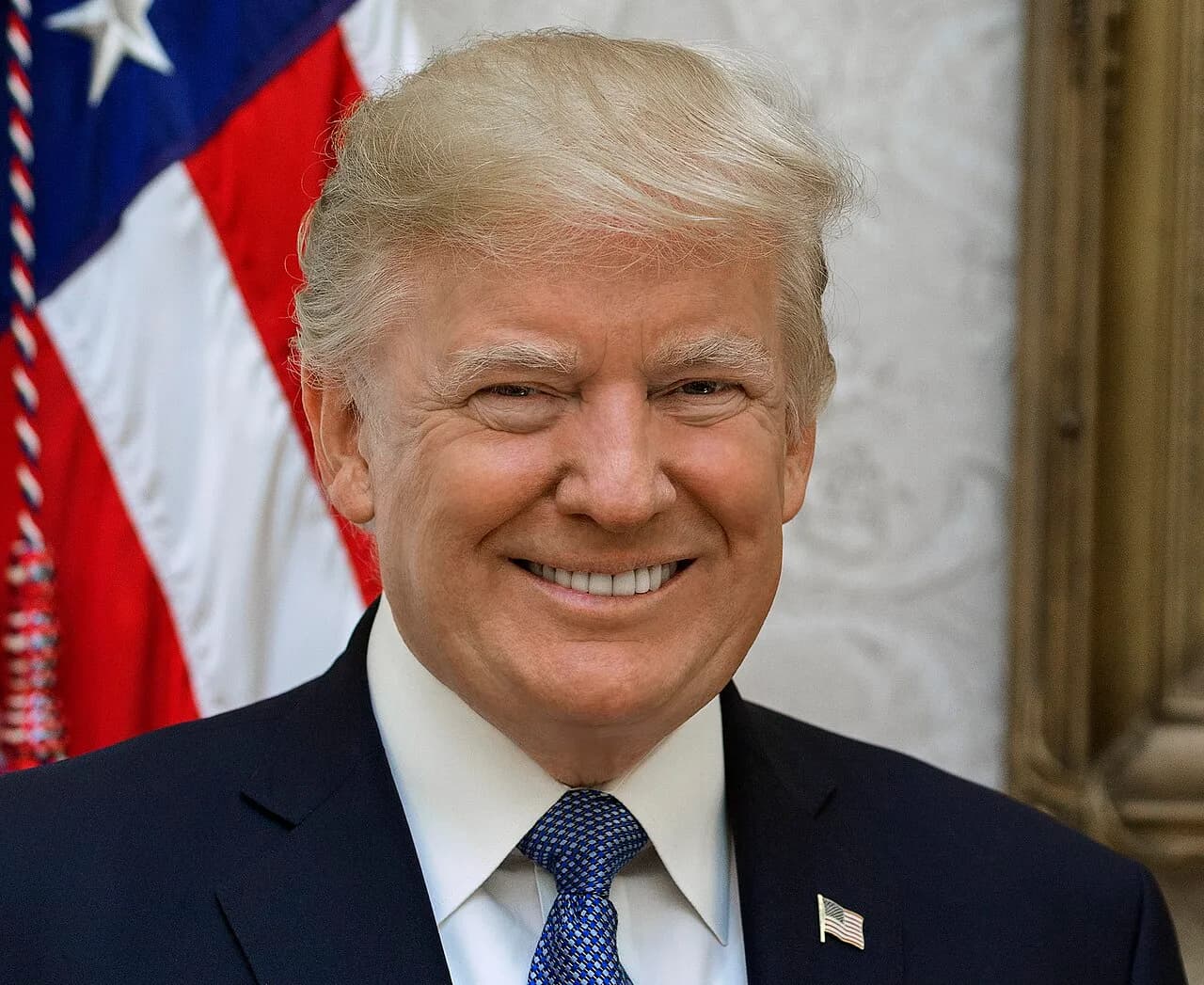 Donald Trump poses for an official portrait with a U.S. flag behind him