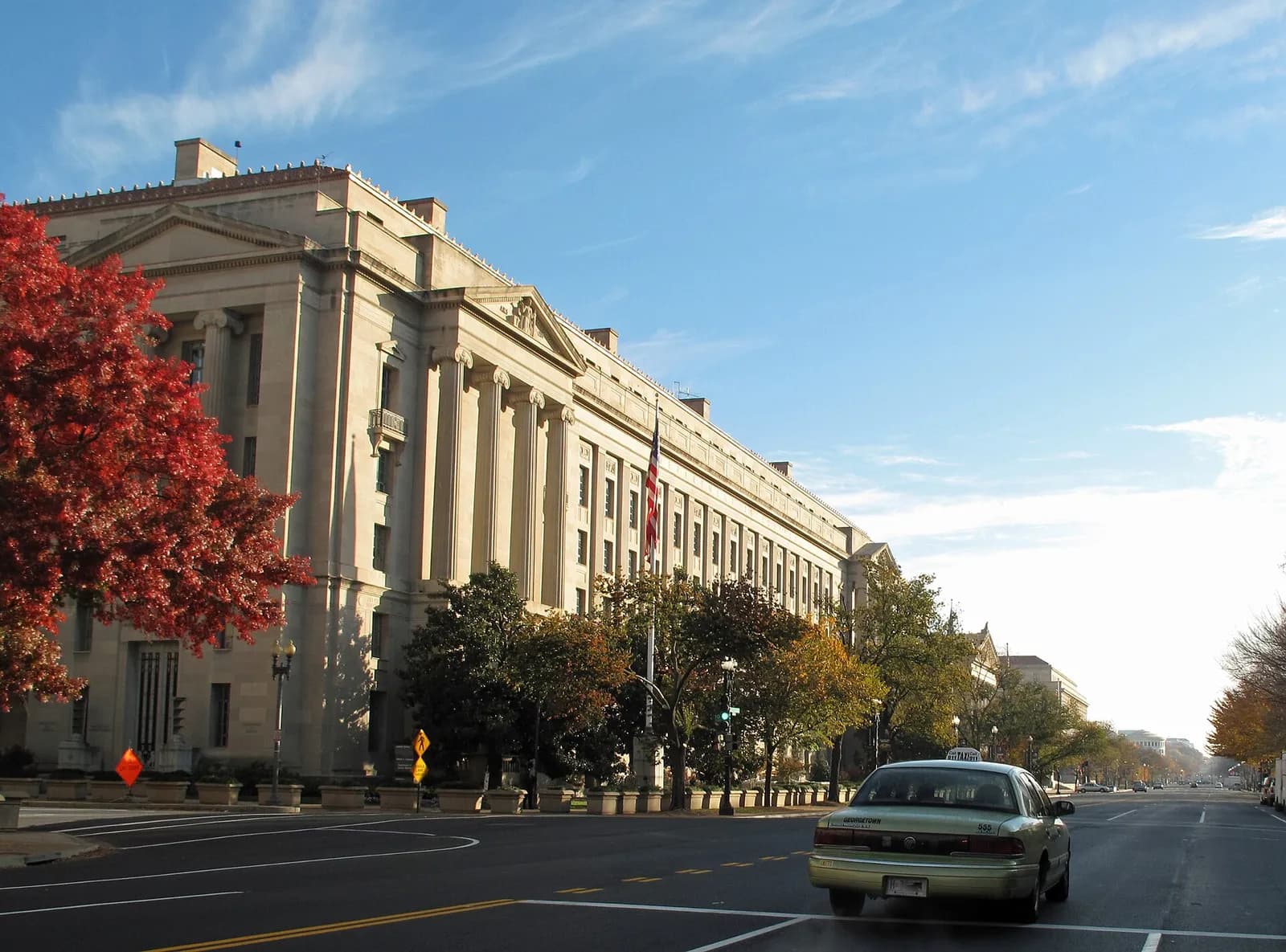 The Robert F. Kennedy Department of Justice Building beside a road.