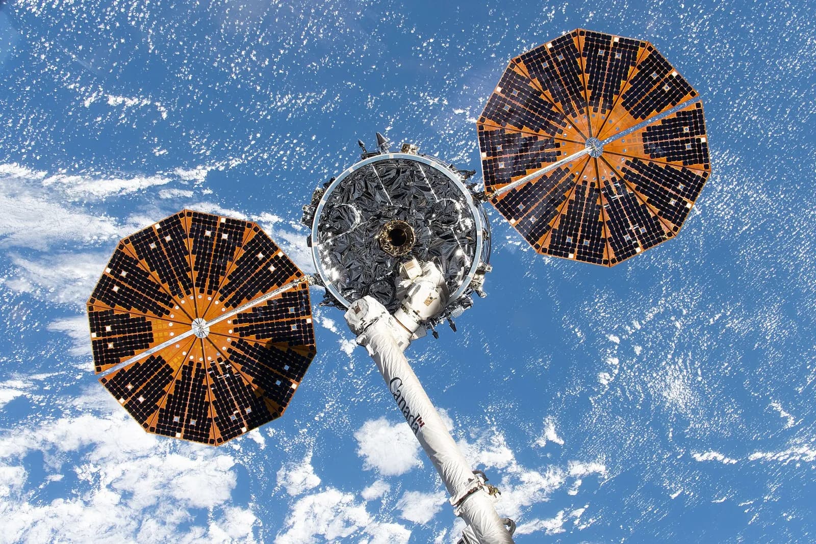 An earlier Cygnus XL cargo spacecraft from the NG-23 mission held by the Canadarm2 robotic arm outside the International Space Station.