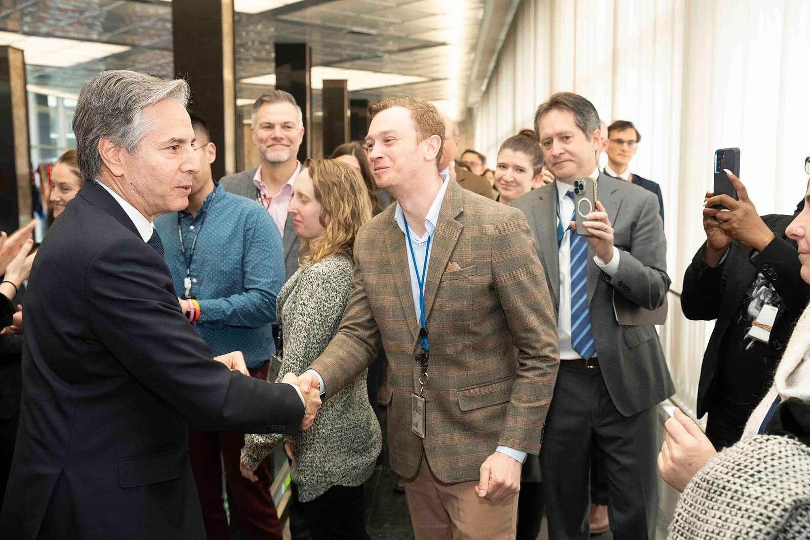 Antony Blinken shakes hands with a man at the U.S. Department of State.