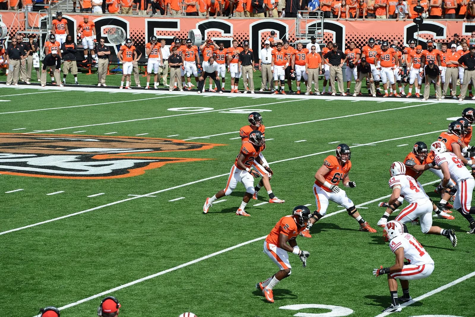 Oregon State Beavers players face the Wisconsin Badgers defense during a football game.