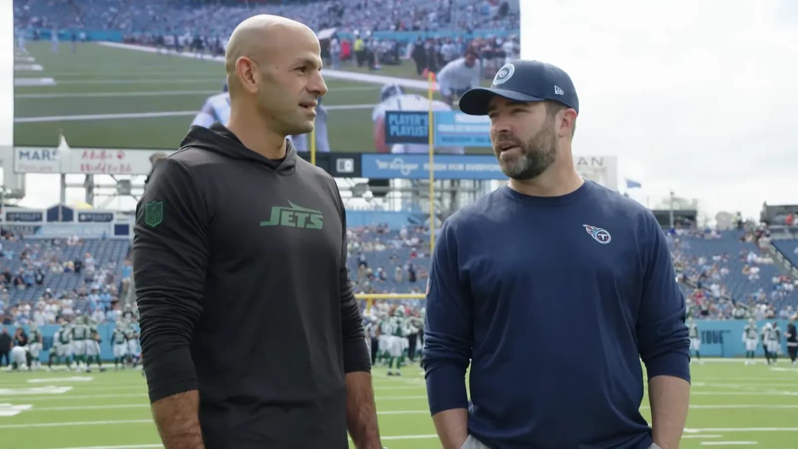Robert Saleh and Brian Callahan speak before a game at Nissan Stadium.