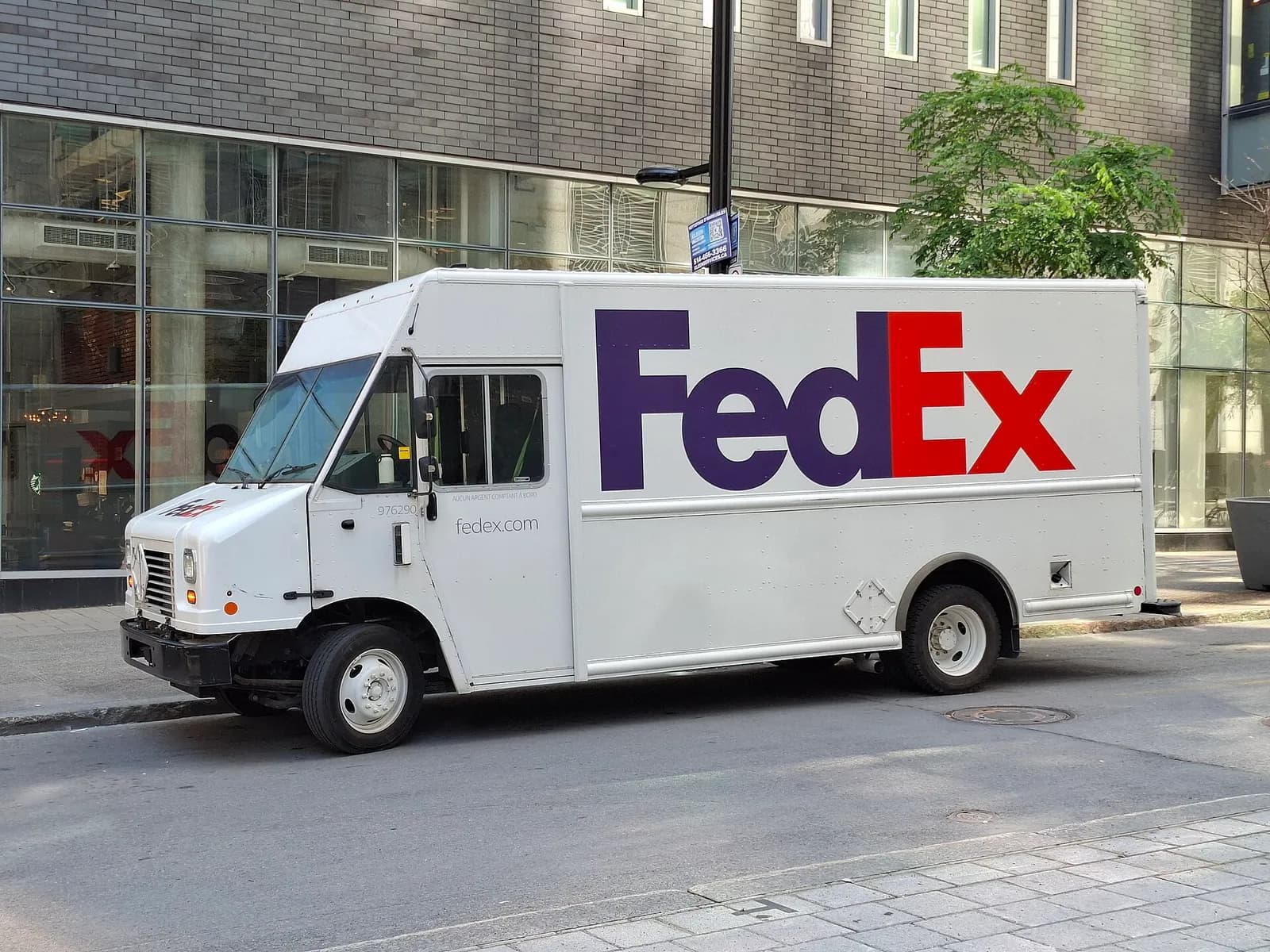 A FedEx delivery vehicle parked on Rue Drummond in Montreal, near Centre Bell.