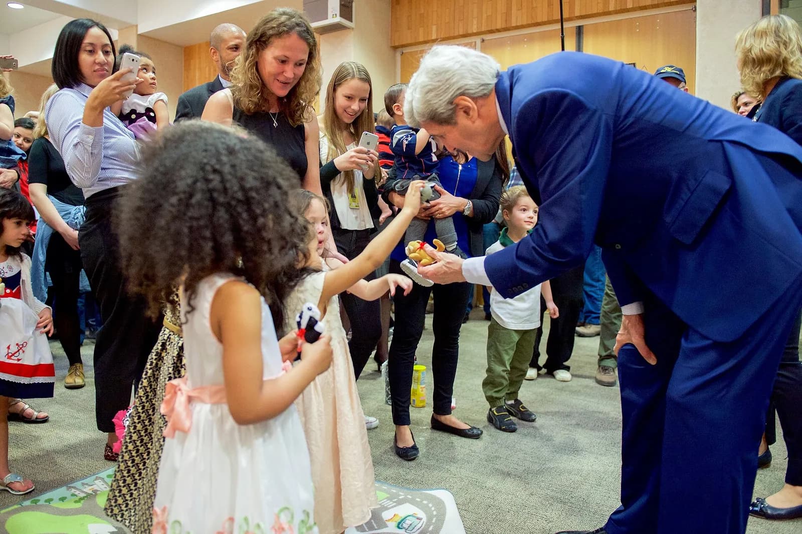 U.S. Secretary of State John Kerry greets children of embassy workers at the U.S. Embassy in Riyadh.
