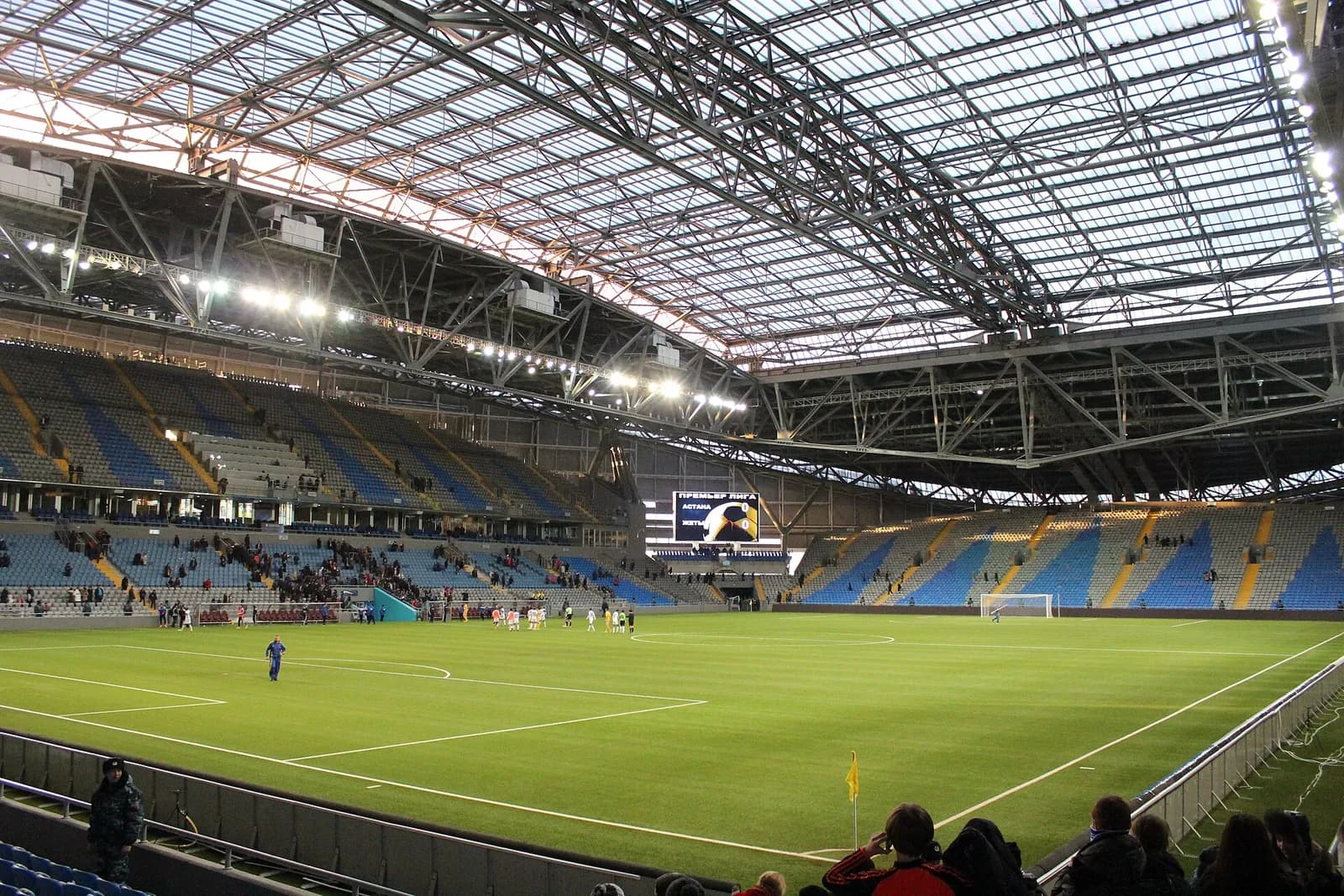 Interior of Astana Arena, with the football pitch and seating visible.