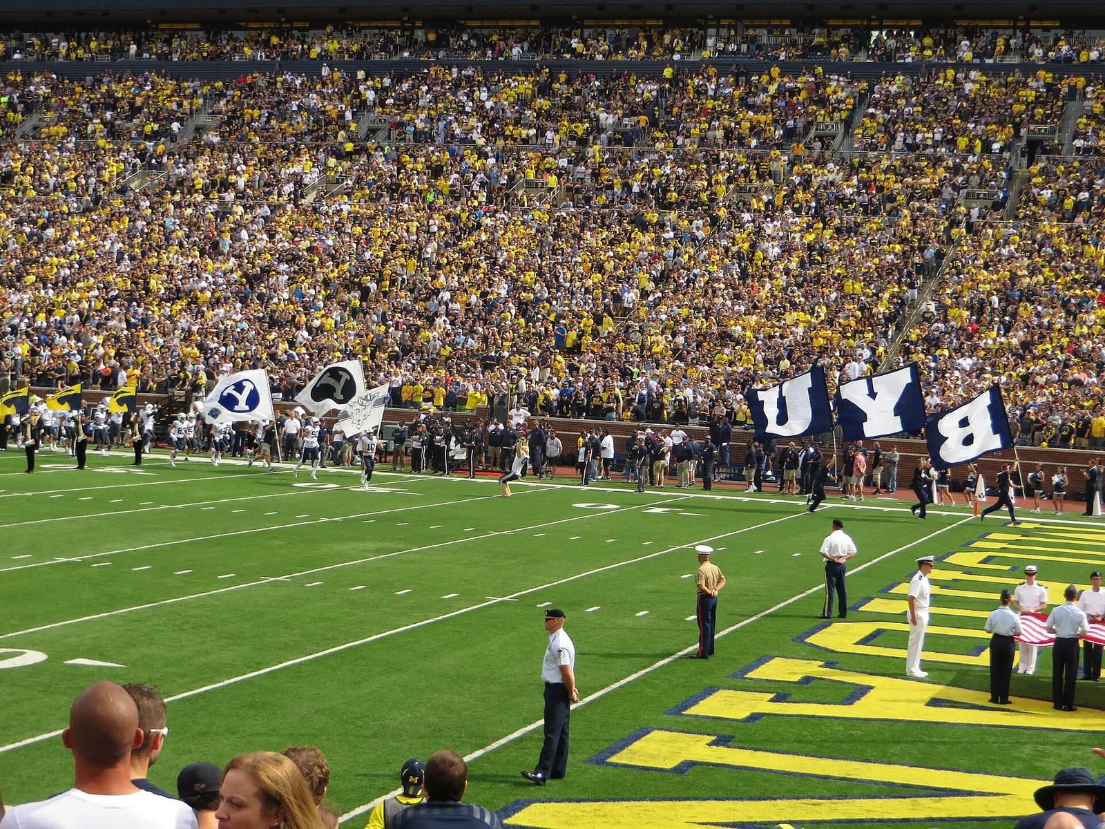 BYU football players take the field at Michigan Stadium in Ann Arbor.
