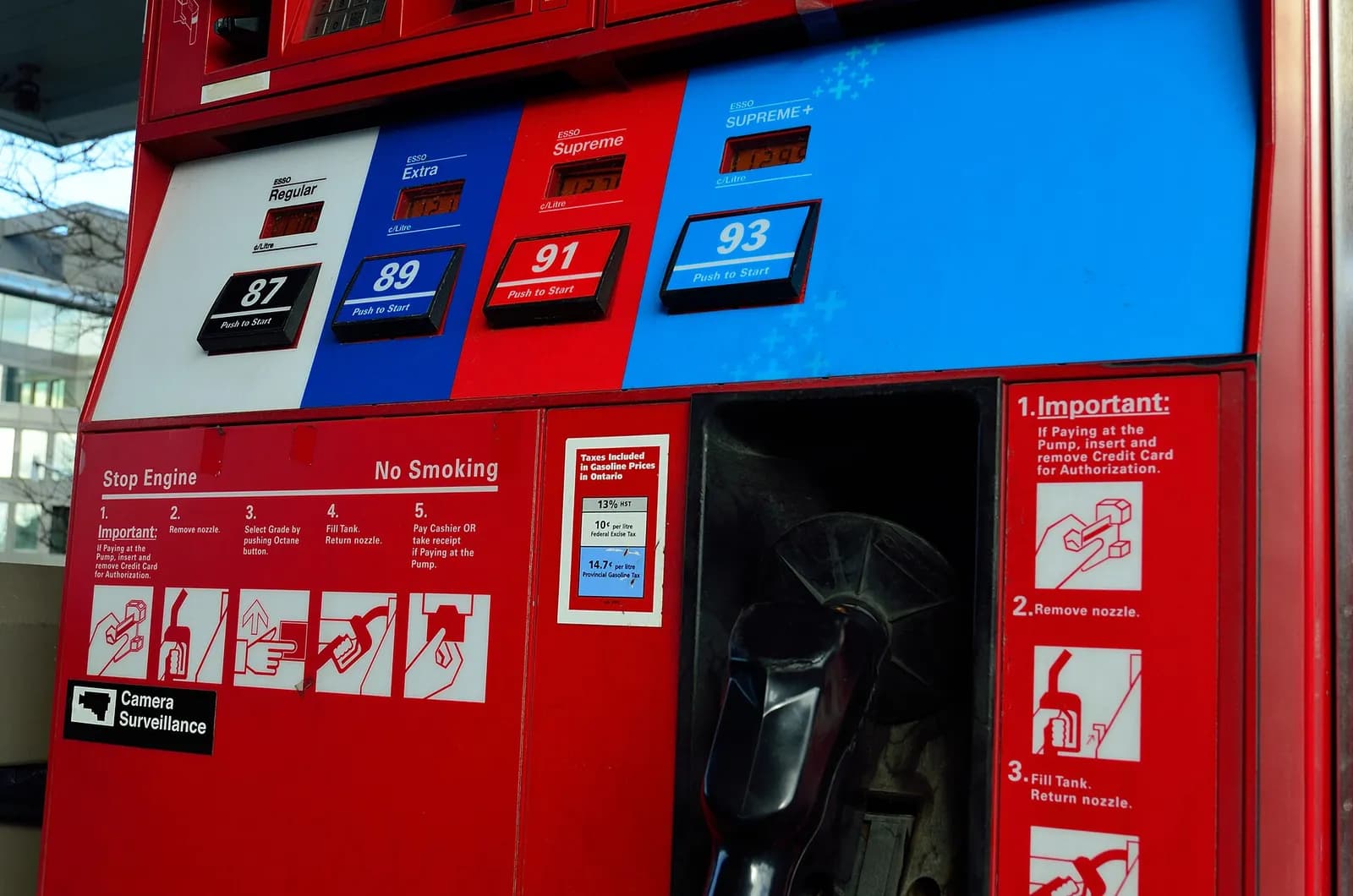 A petrol pump and payment terminal at a service station.