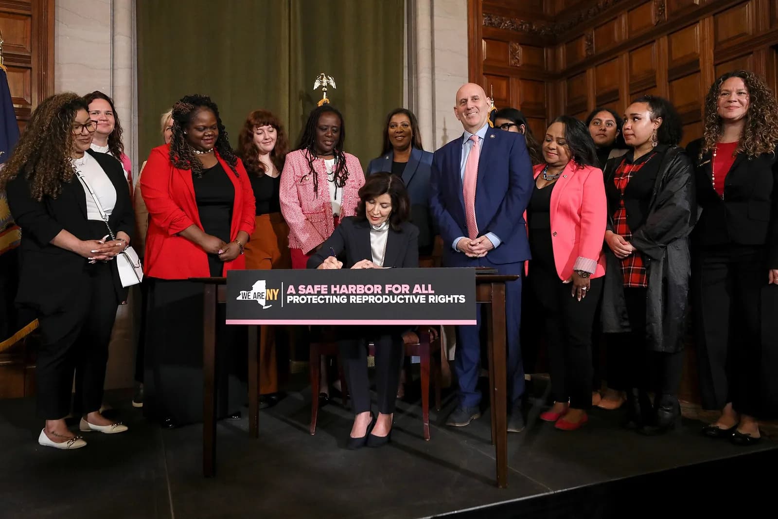 Governor Kathy Hochul at a bill signing with New York state senators in the Red Room of the Capitol in Albany.