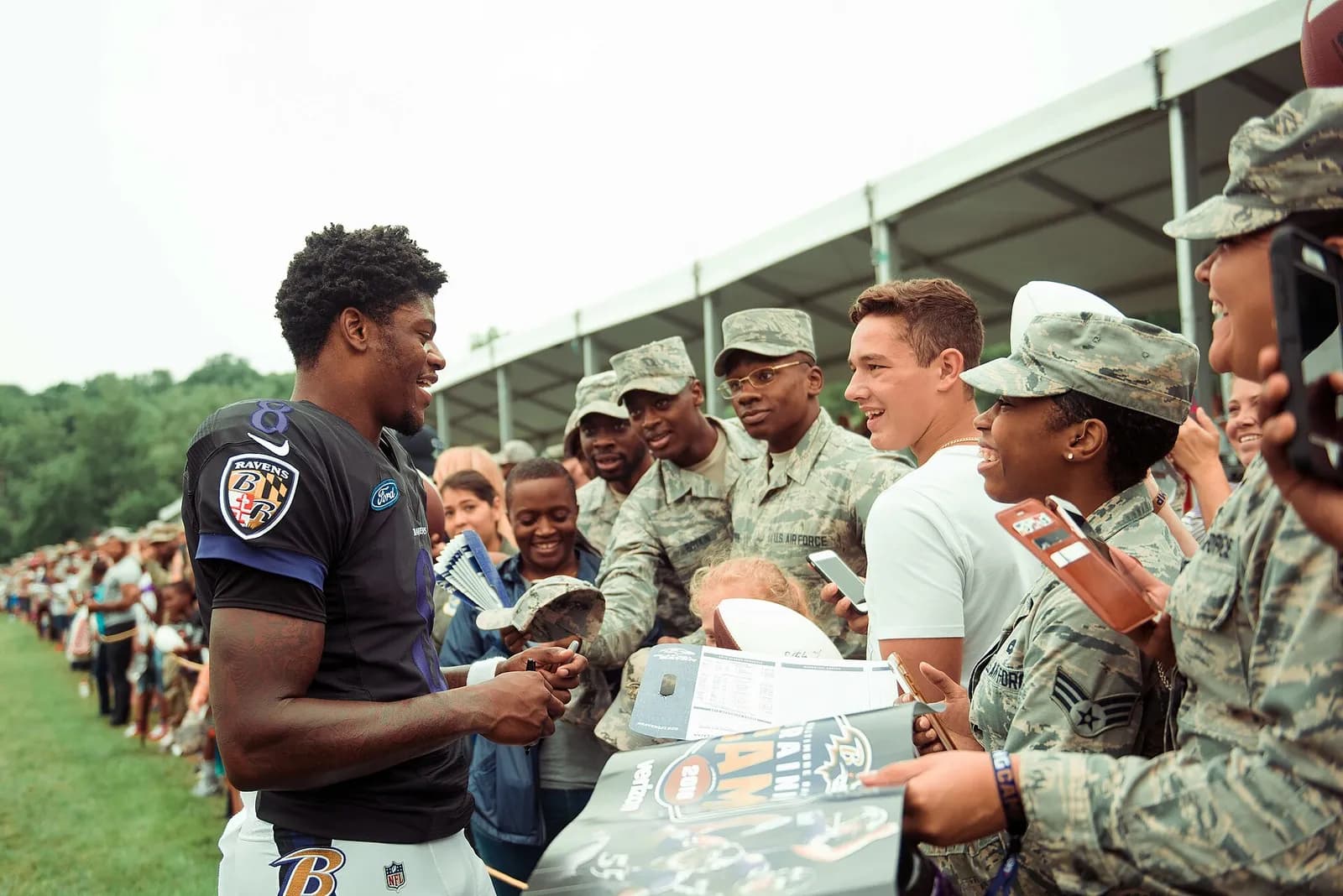 Lamar Jackson interacts with service members at Baltimore Ravens training camp in Owings Mills, Maryland.