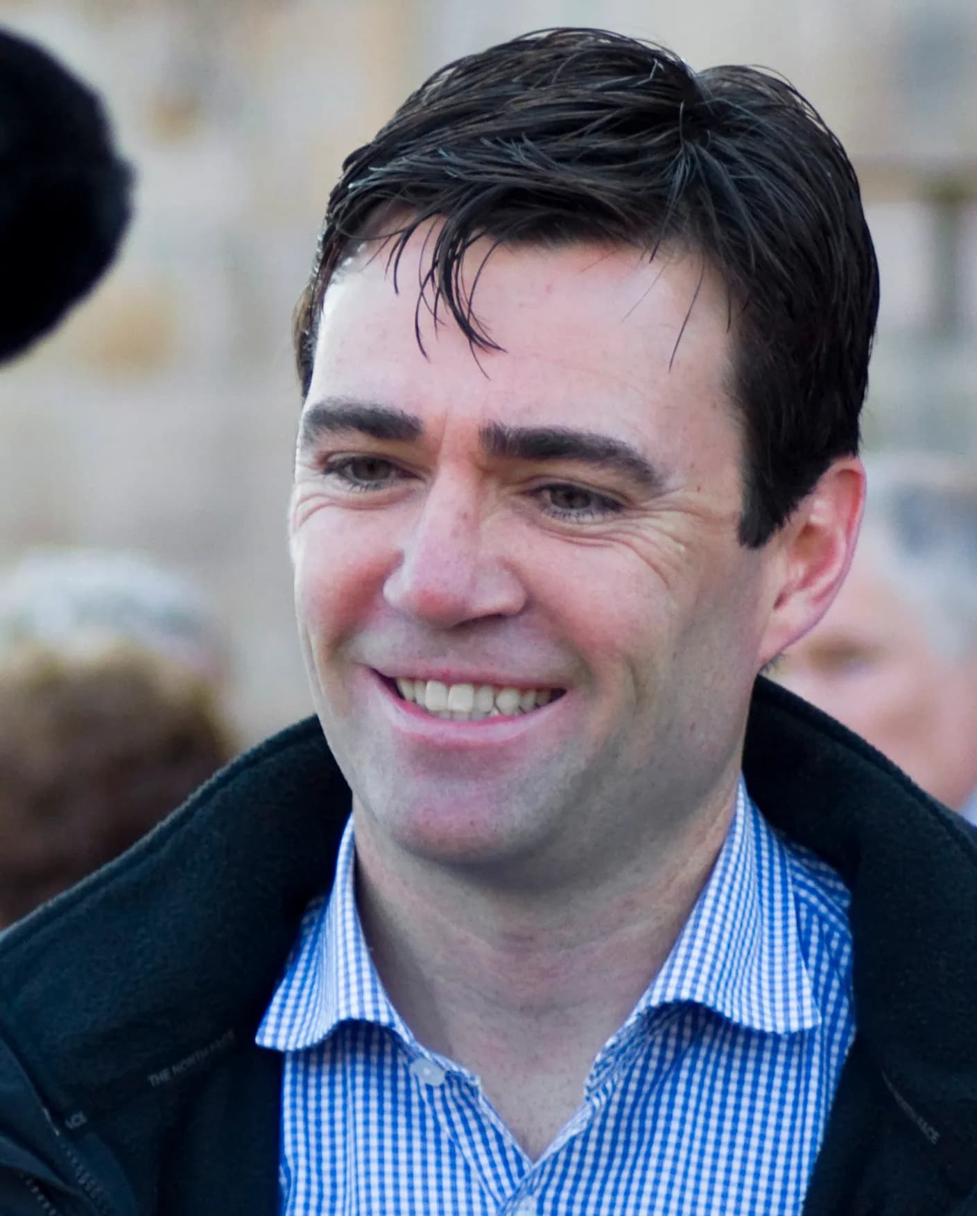 Andy Burnham speaking in front of a television camera.