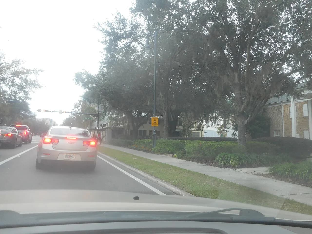 Road sign warning of low-speed autonomous vehicles beside a street in Gainesville, Florida