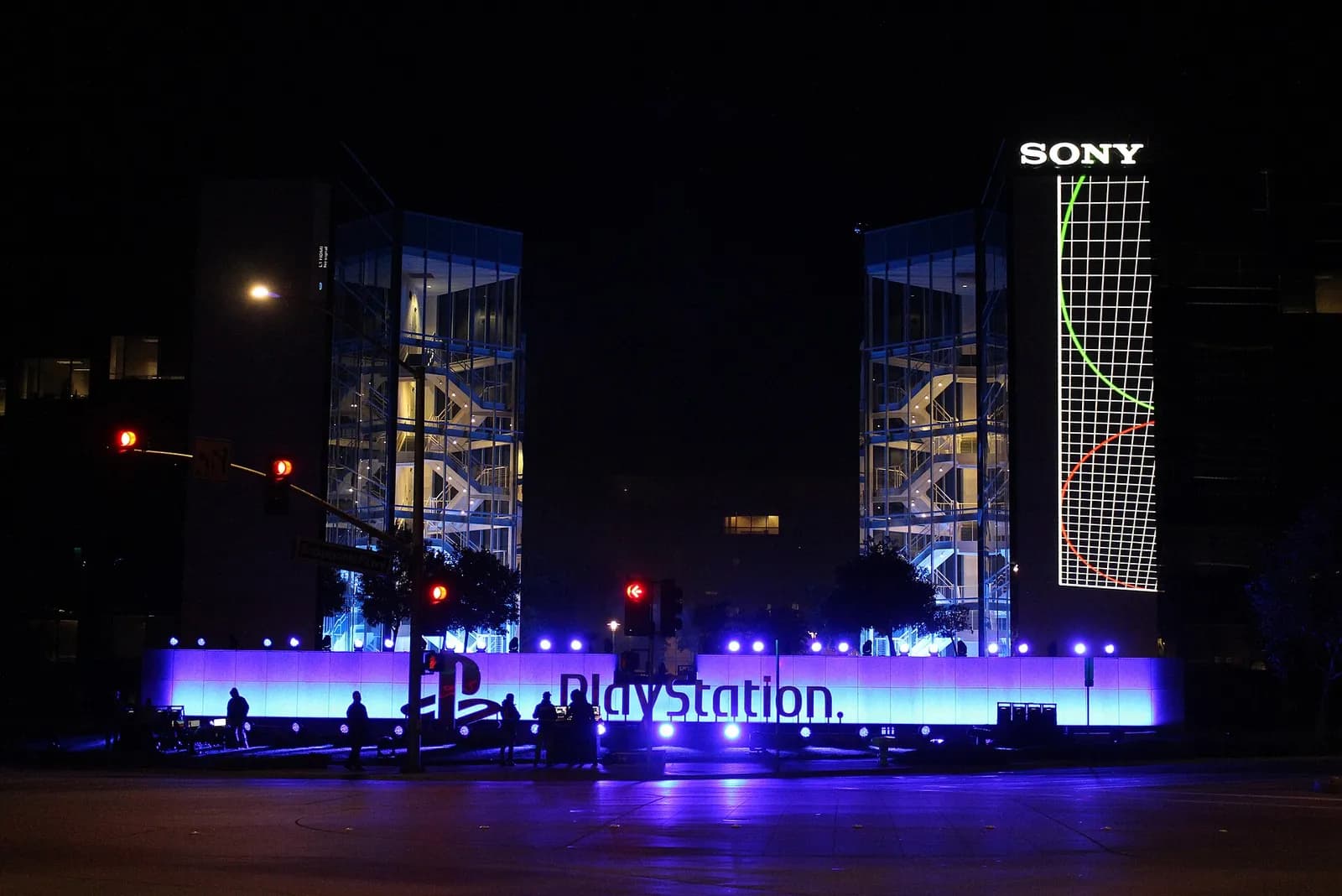 Sony Interactive Entertainment headquarters at night, with event lighting in the sky.