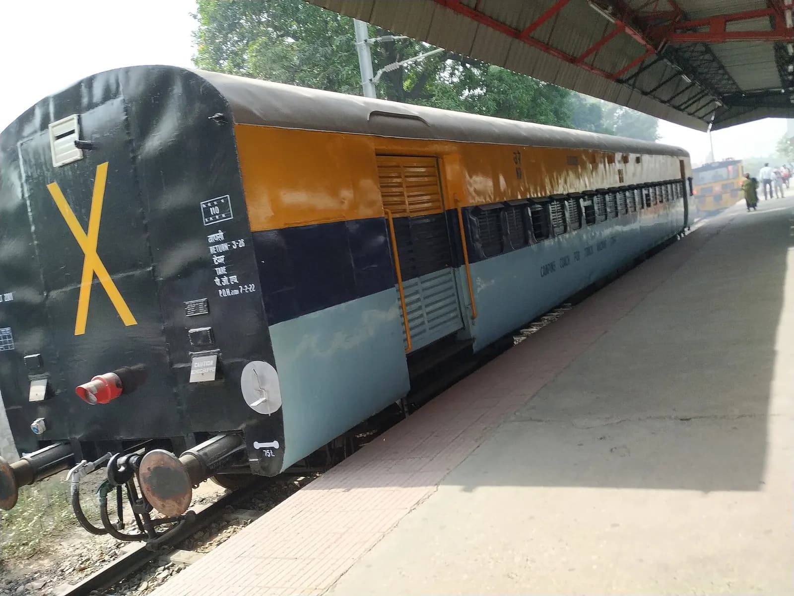 Indian Railways camp coach used by track machine staff, standing at Meerut City railway station.