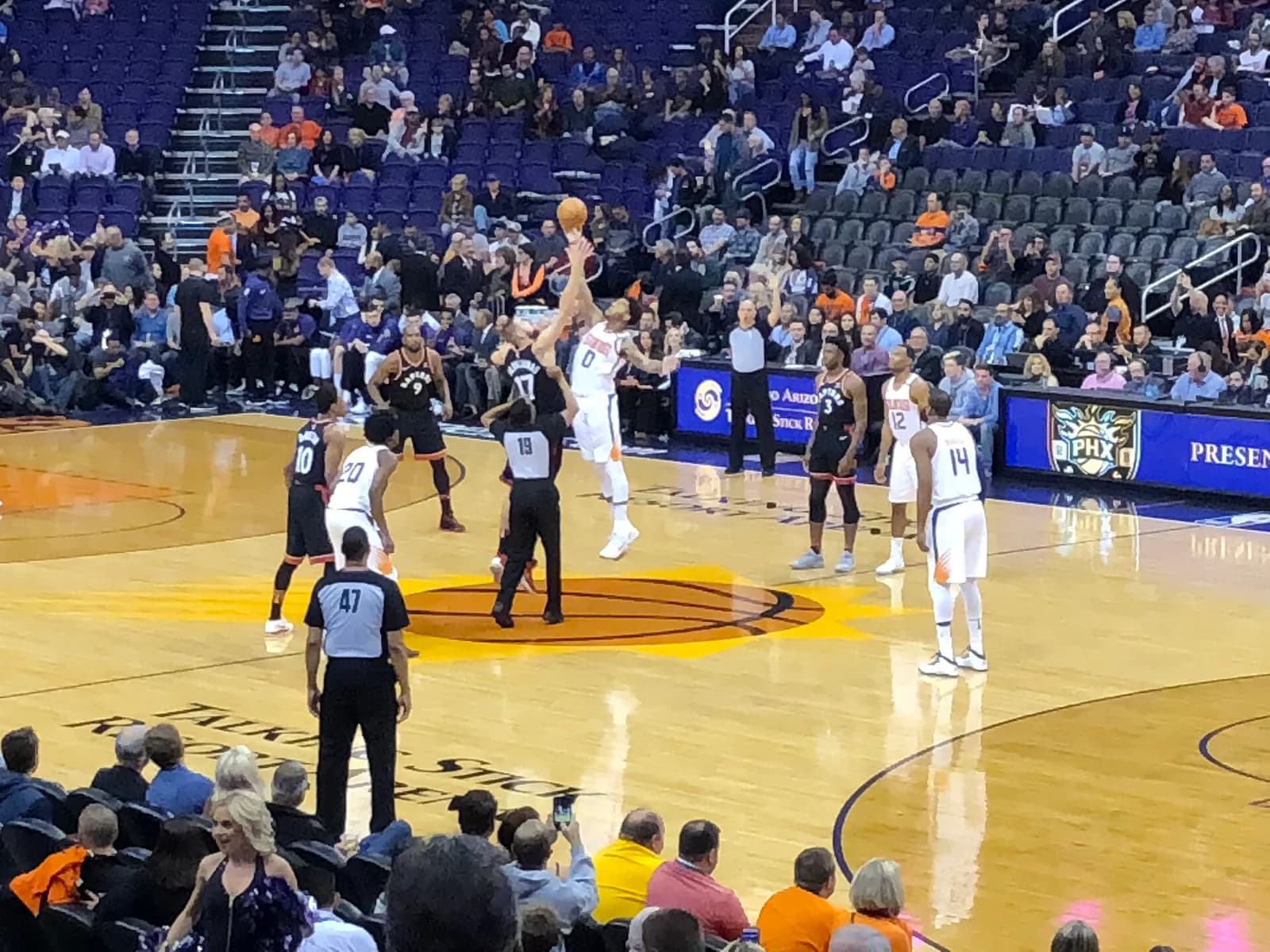 Toronto Raptors and Phoenix Suns players on the court during an NBA game in Phoenix.