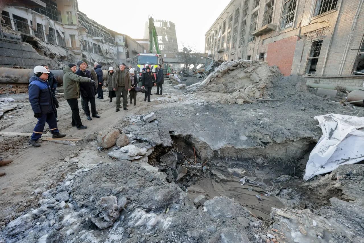 Damage at the Darnytska Combined Heat and Power Plant in Kyiv, with officials inspecting the site.