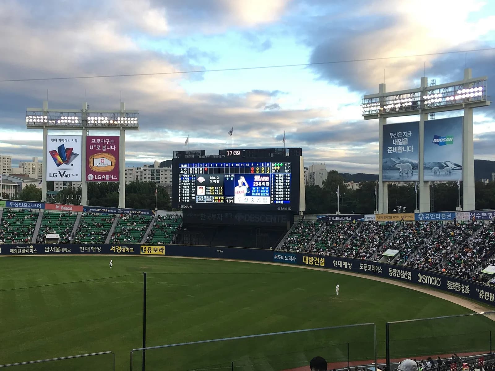 The stands and field at Jamsil Baseball Stadium during a Doosan Bears–LG Twins game, with players visible in the distance.
