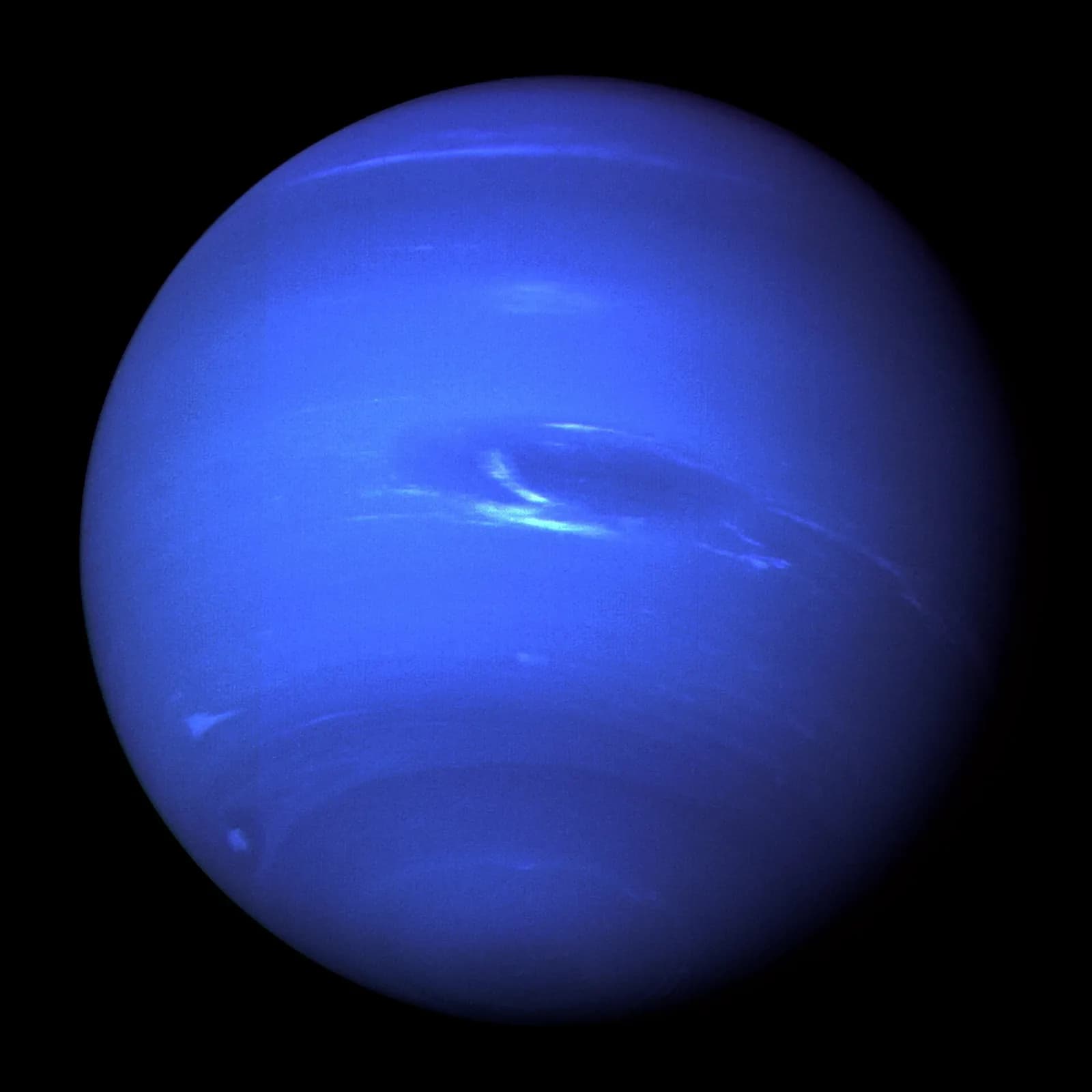 Neptune with the Great Dark Spot and bright cloud features, photographed by Voyager 2.