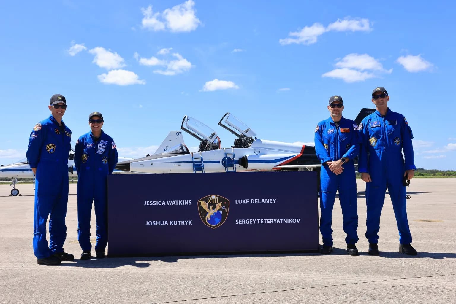 Crew-13 members Joshua Kutryk, Jessica Watkins, Luke Delaney and Sergey Teteryatnikov stand together at Kennedy Space Center in Florida.