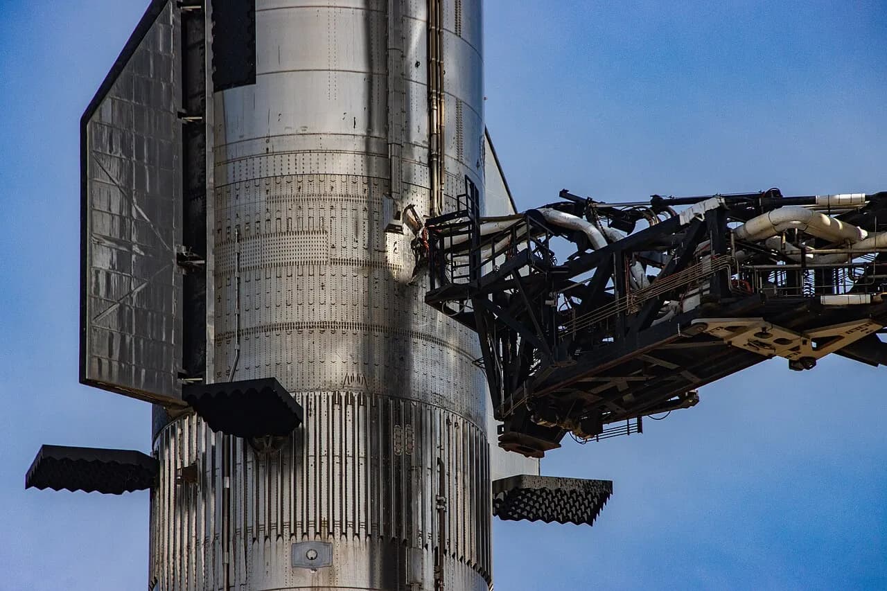 SpaceX Starship and Super Heavy stacked beside the launch tower at Starbase, Texas, in April 2023