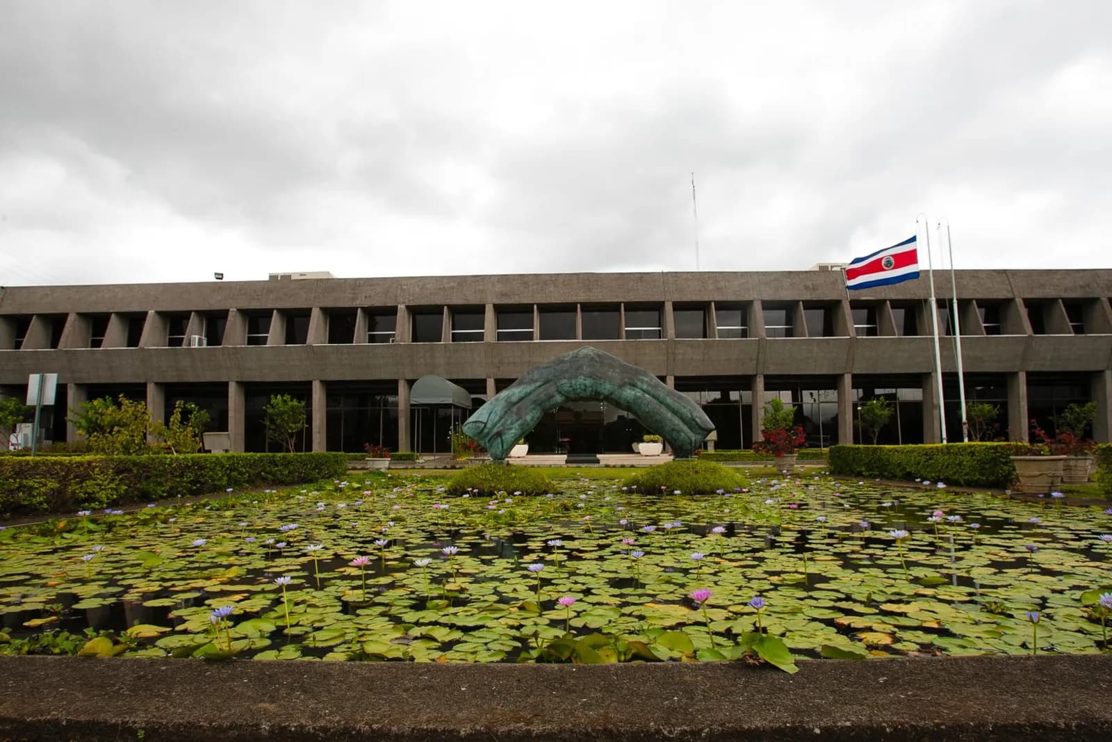Exterior of Costa Rica’s Casa Presidencial, with a reflecting pond in the foreground.