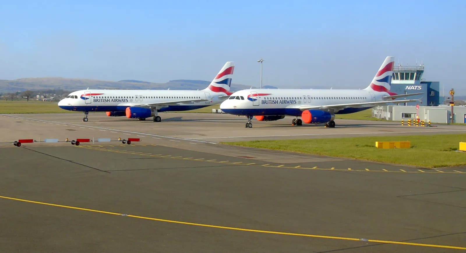 A British Airways Airbus A320 family aircraft parked at Glasgow Airport.