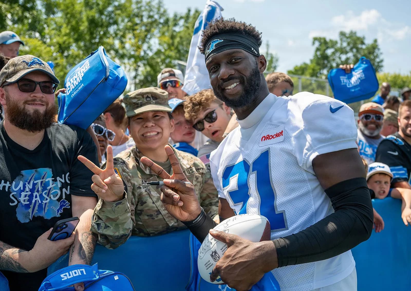 Detroit Lions safety Kerby Joseph poses with a U.S. Army sergeant during a team training camp community event.