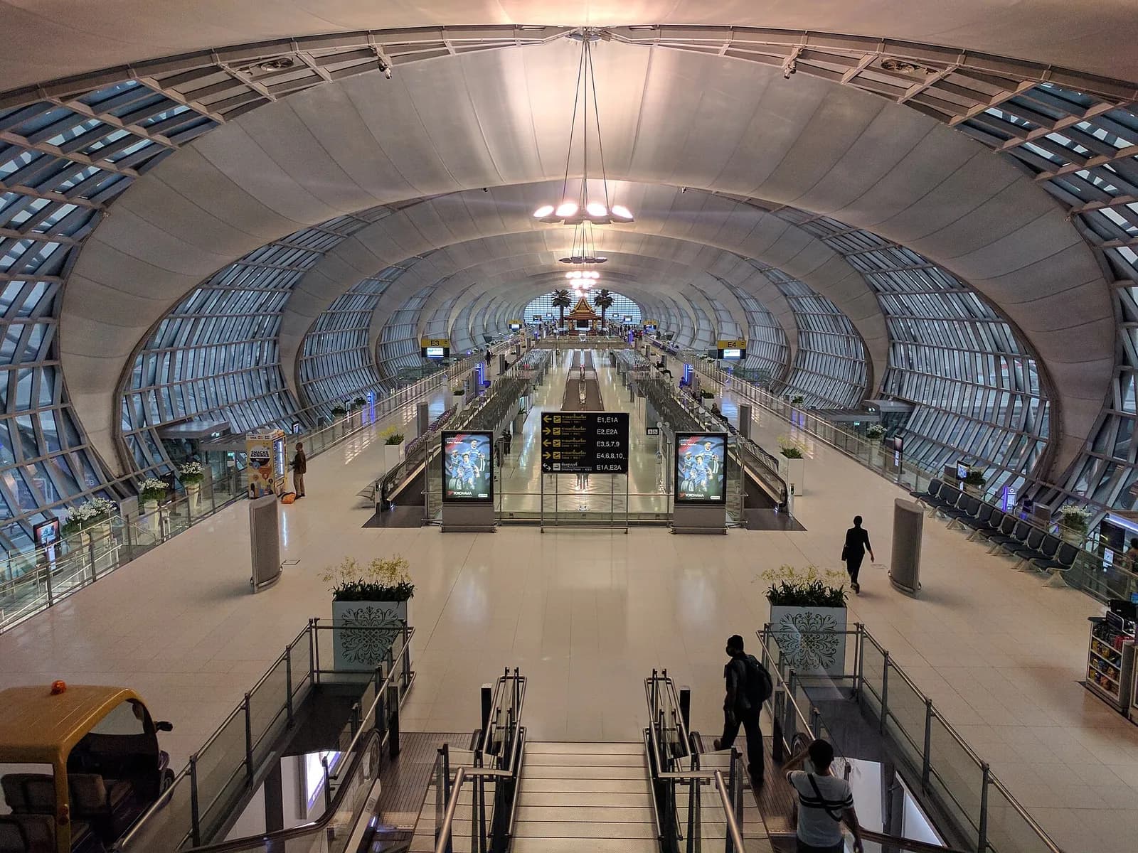 Interior of Terminal E at Suvarnabhumi Airport in Bangkok, seen from an elevated point on the stairs.