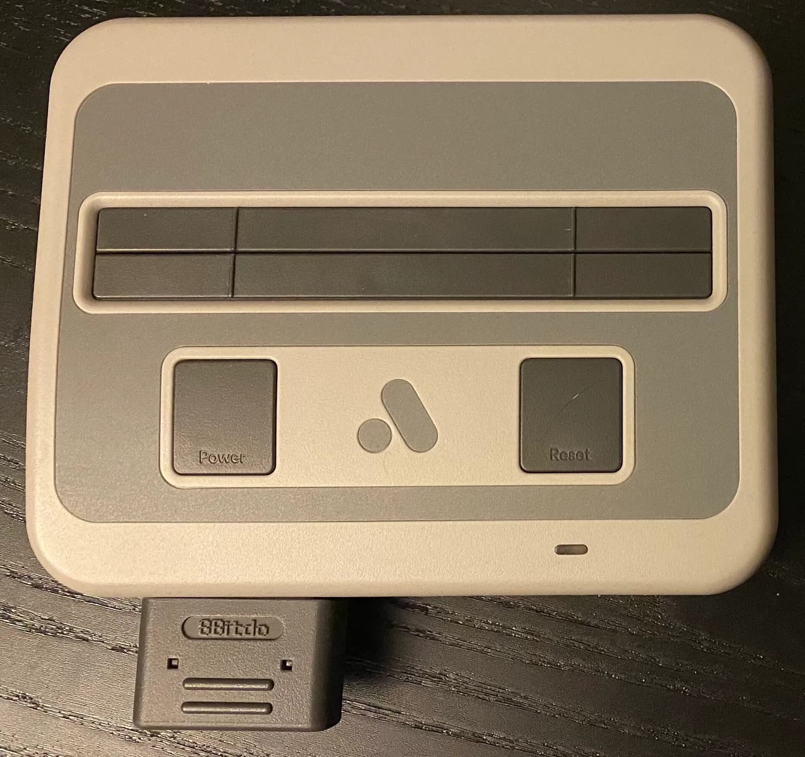 Analogue Super Nt console on a dark surface.