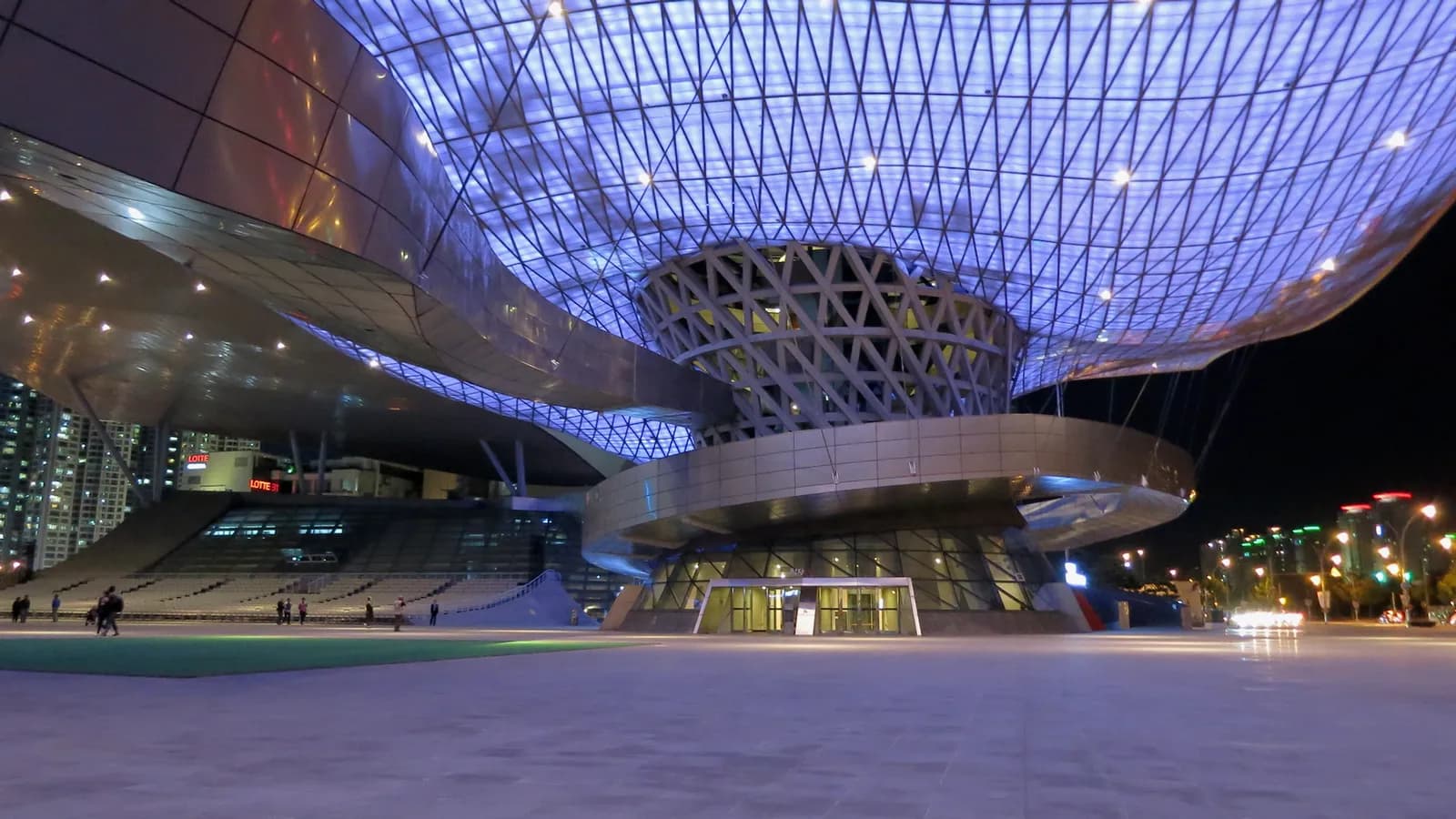 The Busan Cinema Center, a large modern building with a sweeping roof.