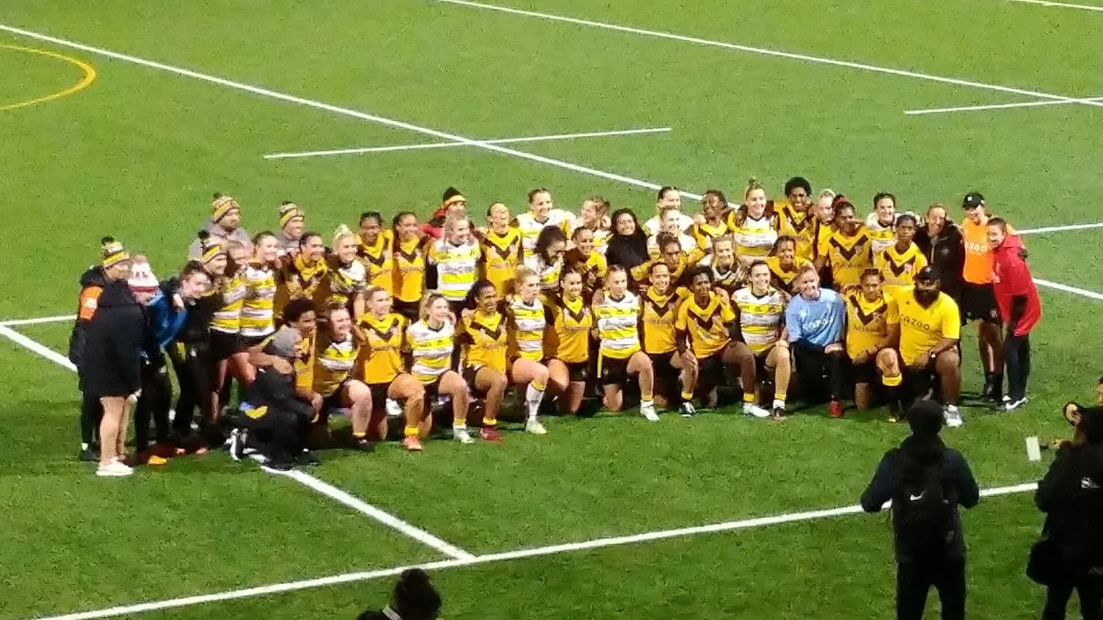 Papua New Guinea Orchids and York Valkyrie pose together after a rugby league match.