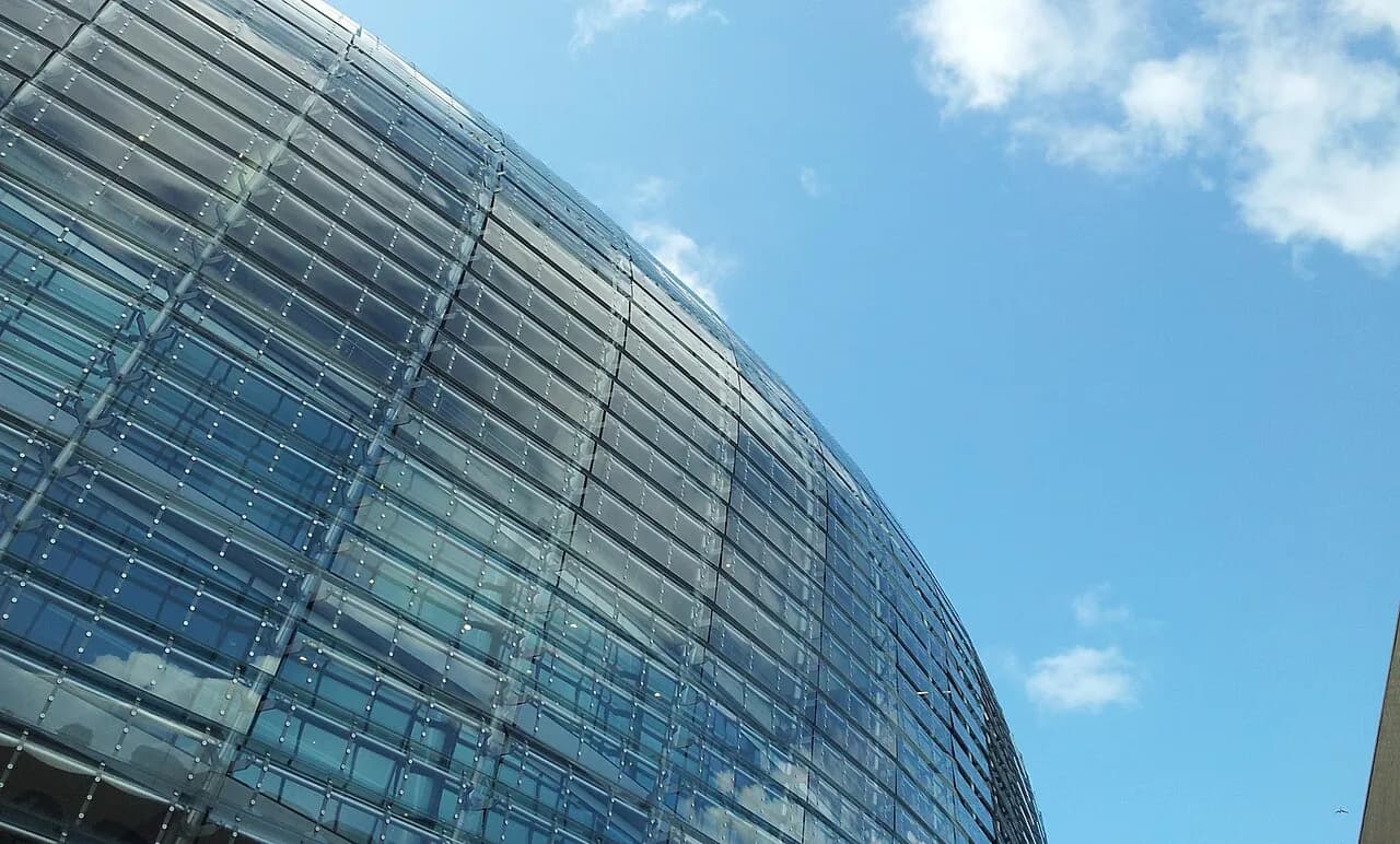 Exterior of Aviva Stadium in Dublin beneath a cloudy sky