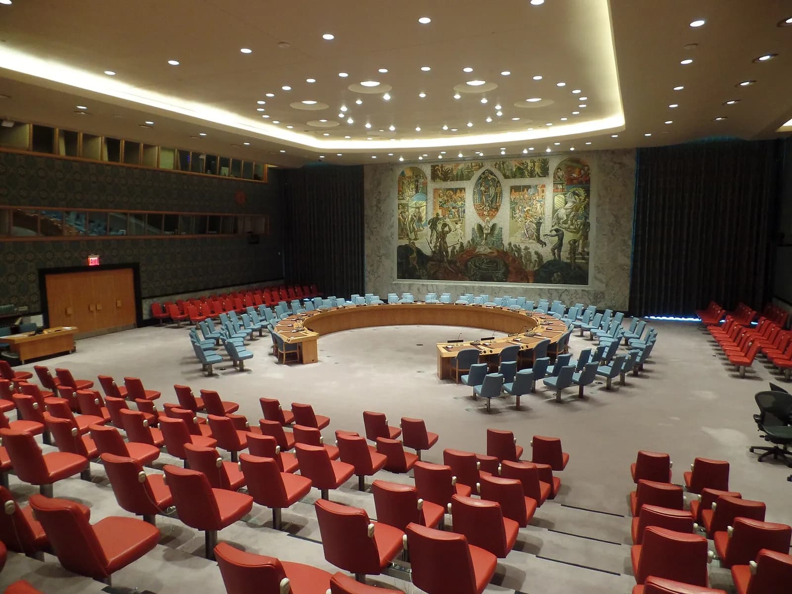 The empty United Nations Security Council chamber in New York, with seats arranged around the council table.