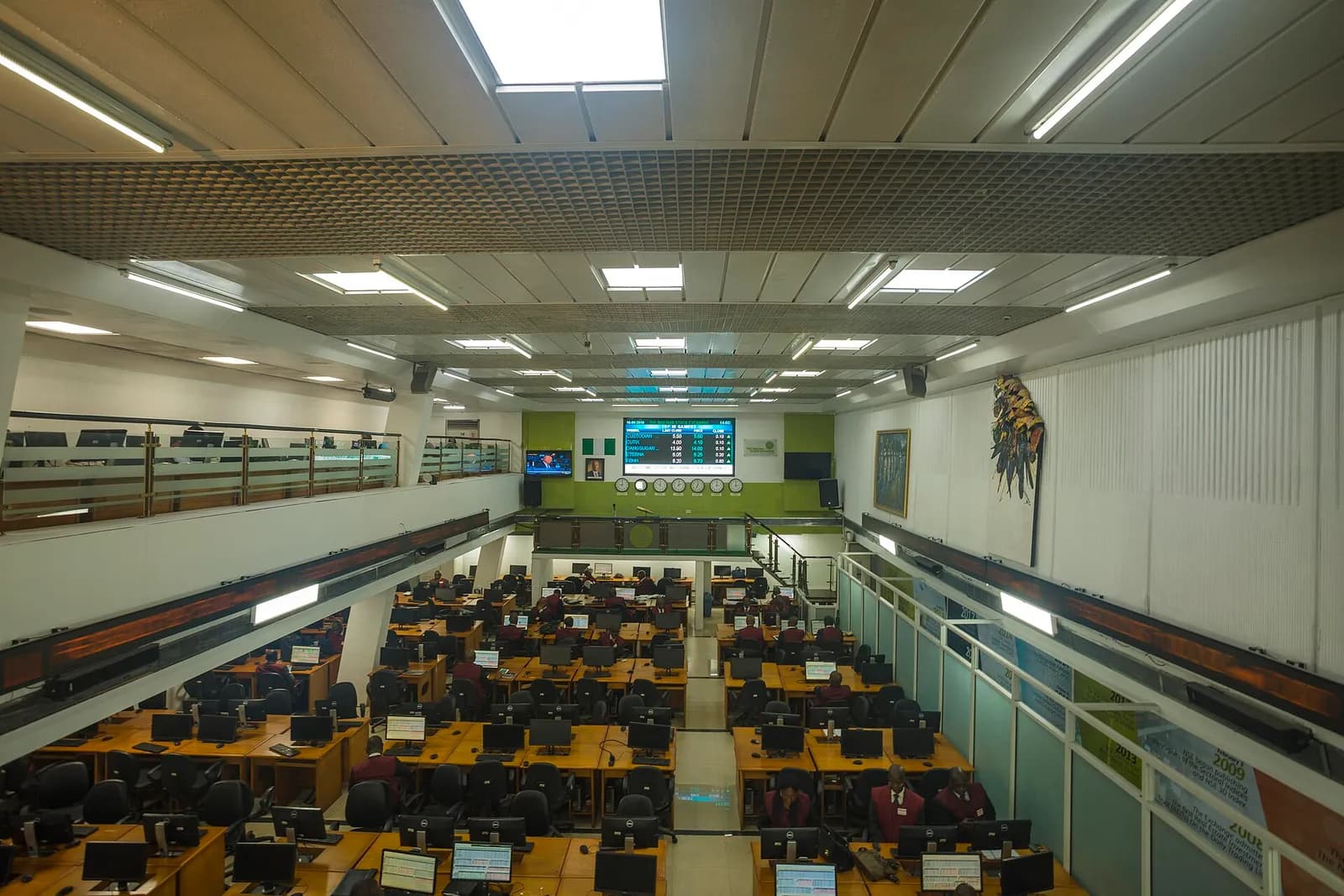 People and screens on a stock exchange trading floor.