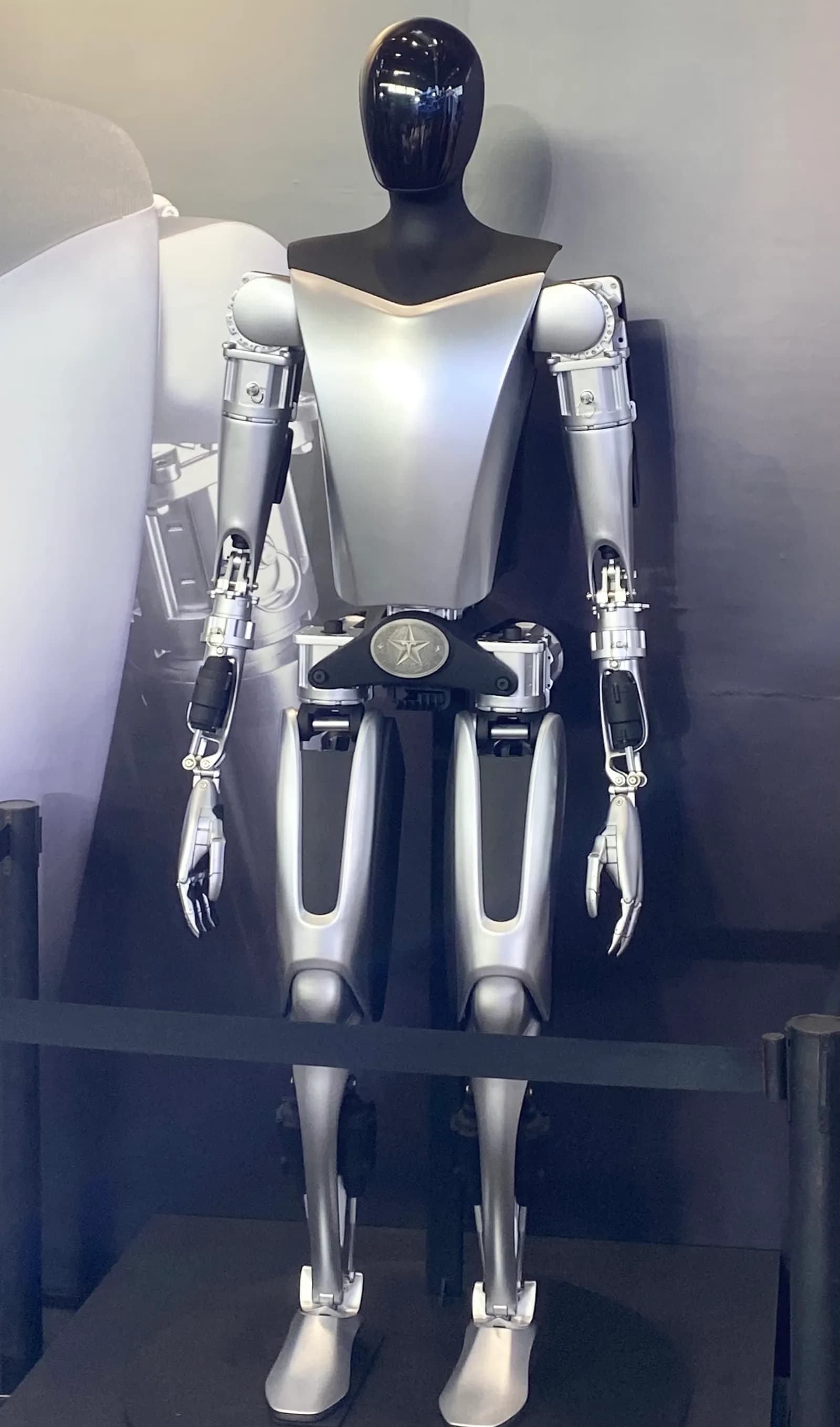 Tesla Optimus humanoid robot displayed at an exhibition.