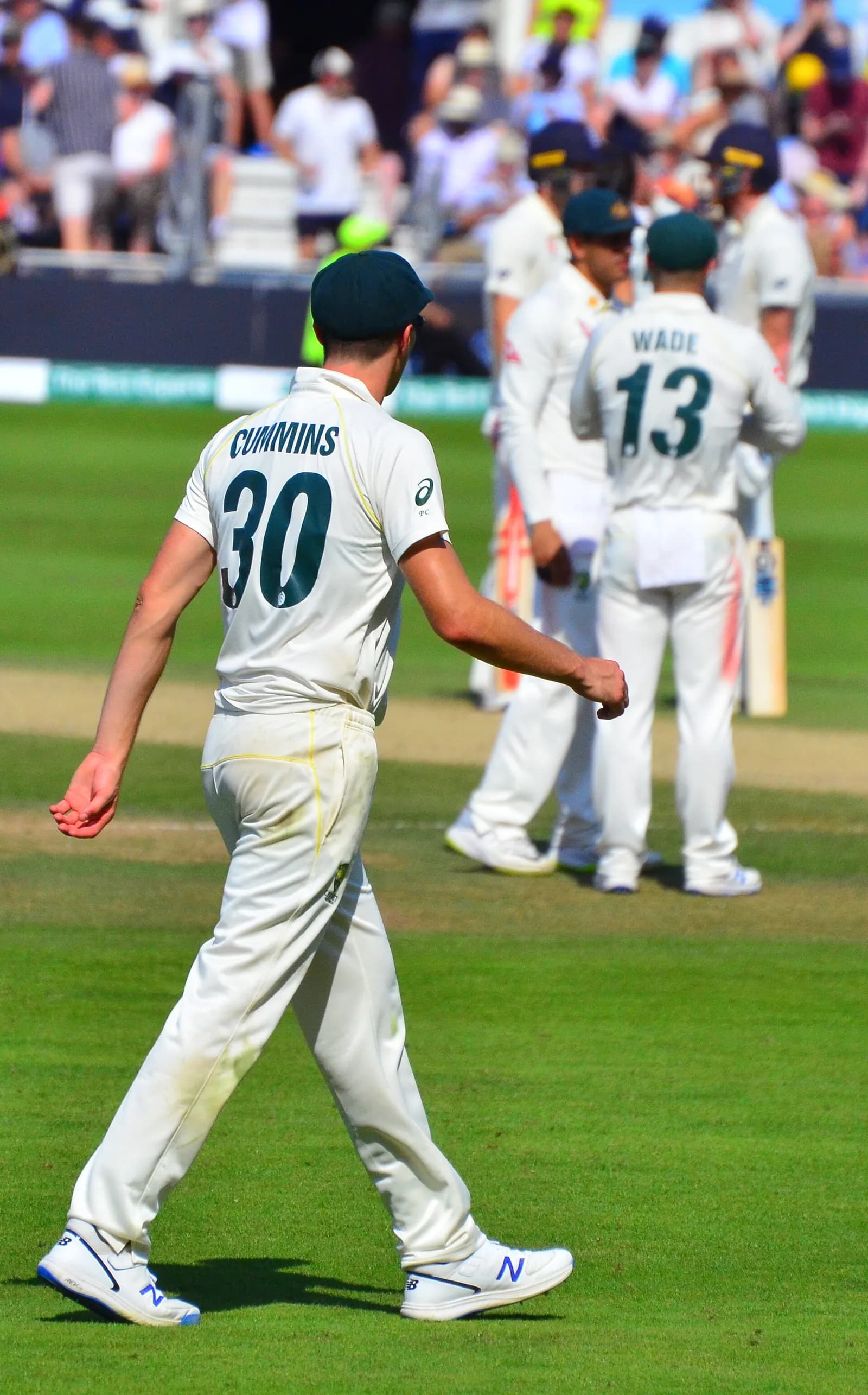 Pat Cummins standing in the field during a cricket match for Australia.