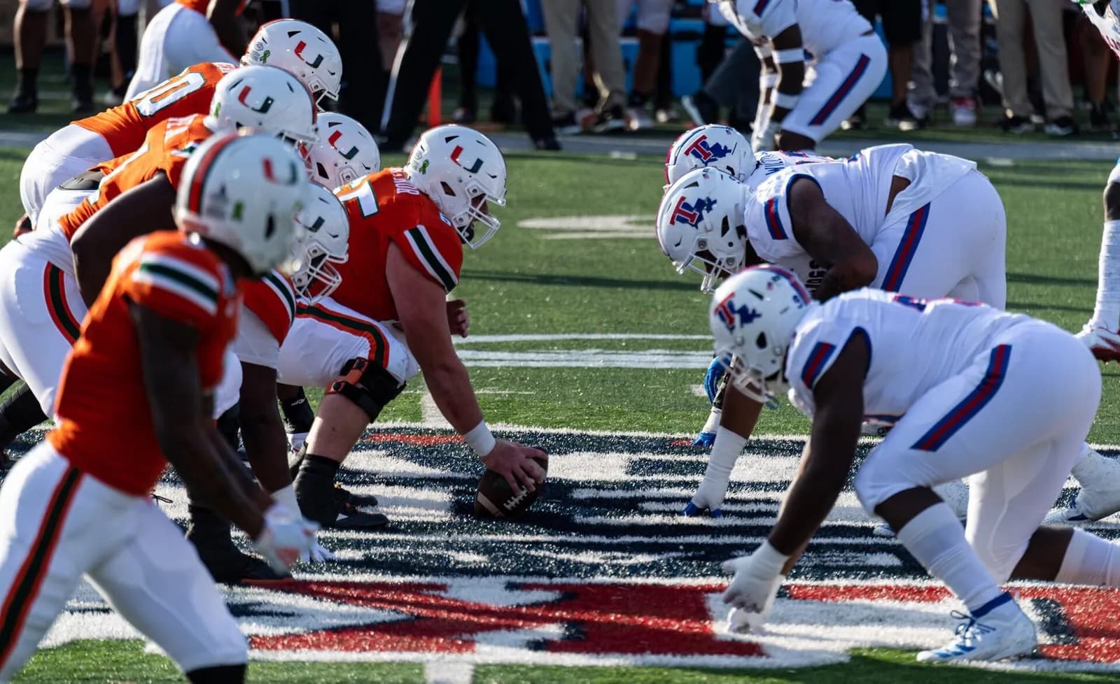 Miami and Louisiana Tech football teams line up before a play at the 2019 Independence Bowl.