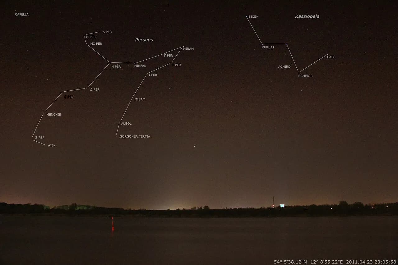 Annotated night-sky photograph showing the constellations Perseus and Cassiopeia over Rostock, Germany.