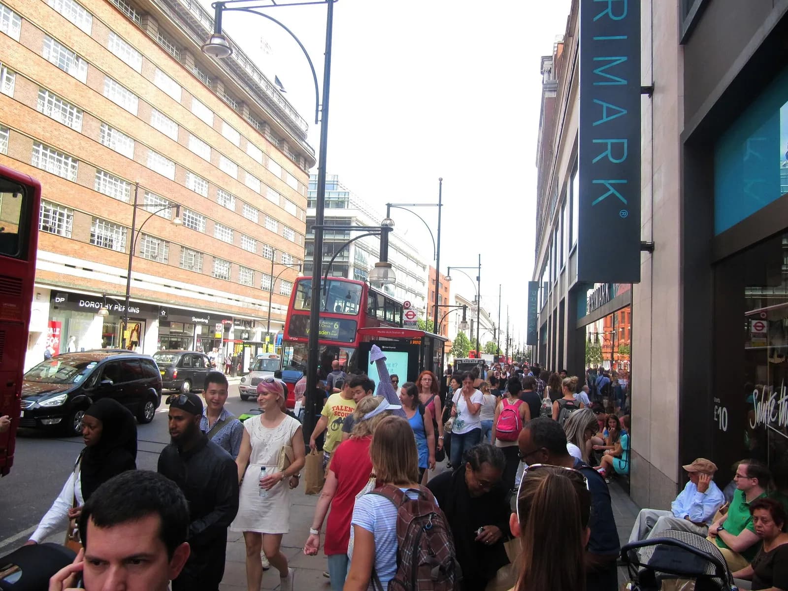 Pedestrians and traffic on Oxford Street in London.