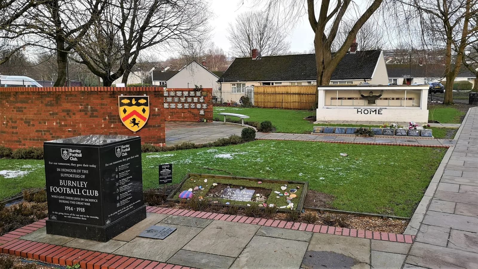 A memorial garden behind the Jimmy McIlroy Stand at Turf Moor, Burnley, with a replica dugout.