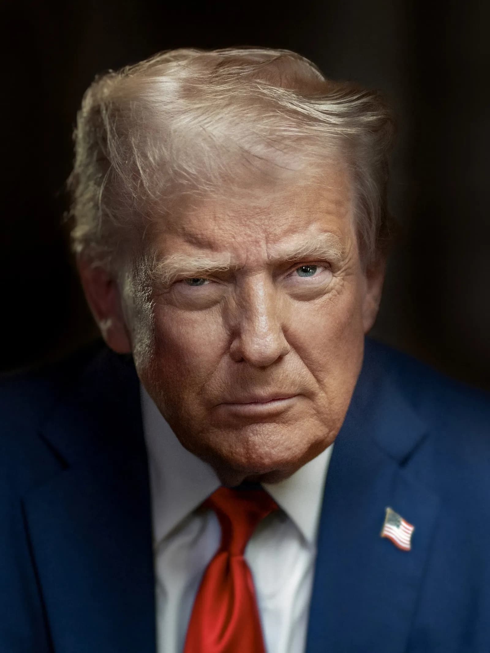 Official portrait of Donald Trump in a dark suit against a blue background