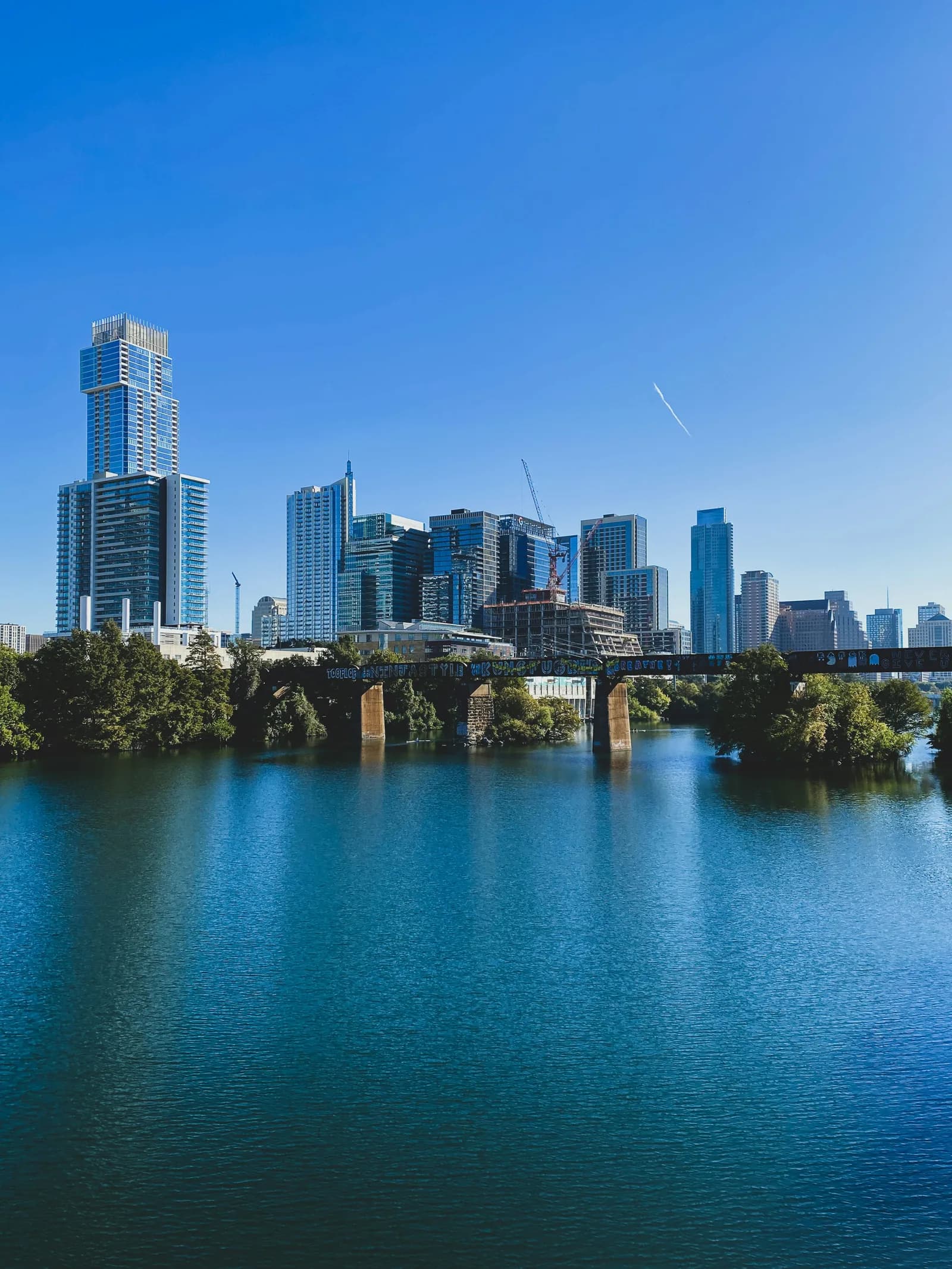 Downtown Austin skyline and lake under a blue sky