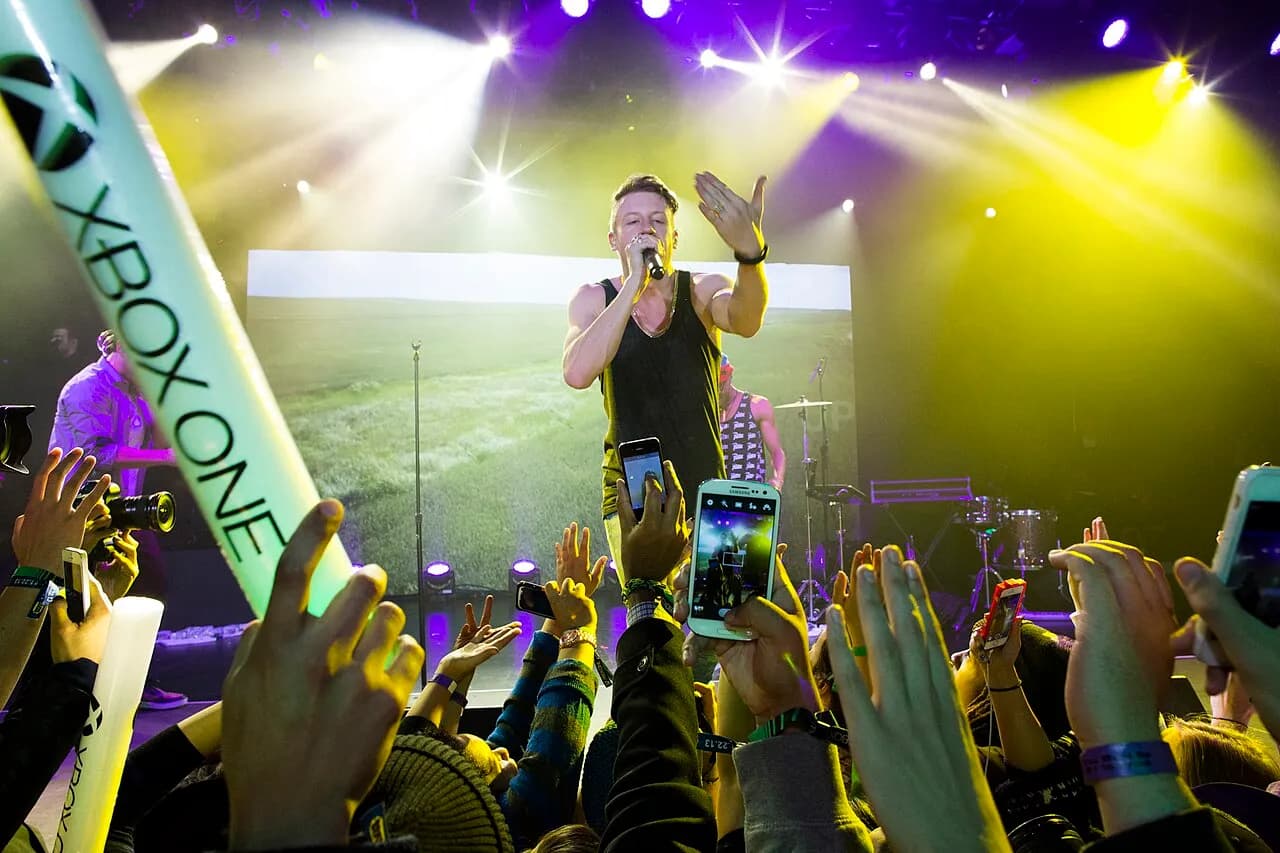 Macklemore performing onstage at the Xbox One launch in New York City in 2013