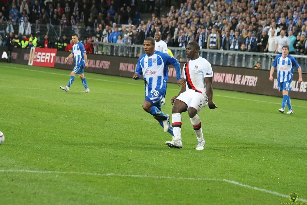 Micah Richards and Luis Henríquez on the pitch during a 2010 football match